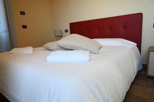 a large white bed with two pillows on it at Locanda Fermento in Mochignano
