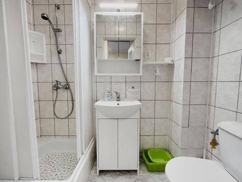 a small bathroom with a sink and a shower at Apartament "Na fali" in Jarosławiec