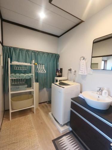 a bathroom with a sink and a washing machine at Onjuku海岸Hana House Private Villa 1 minutes from the beach in Onjuku