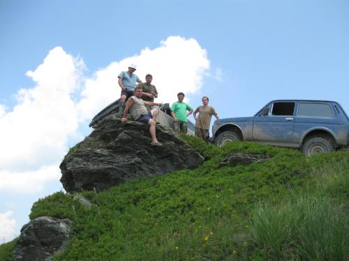a group of people sitting on top of a rock at Котеджі Карпати Fest in Mizhhirʼʼya