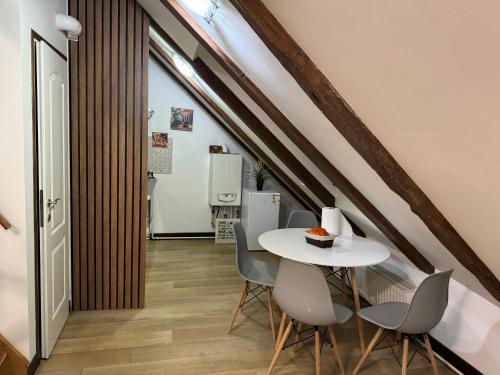 a dining room with a white table and chairs at Mureșenilor Central Residence 2 in Braşov