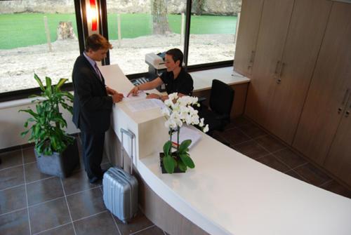 two men standing in an office with a desk at La Pommeraie in Bruz
