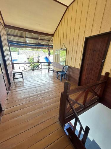 a room with a wooden deck with a bench at Pinks Bungalow in Ban Tai