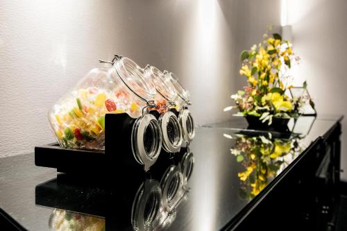 a table with a salad in a bag and glasses at Hotel Lilla Roberts in Helsinki