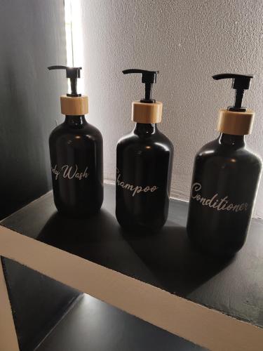 a couple of black bottles sitting on a shelf at Apartman Březinova in Brno