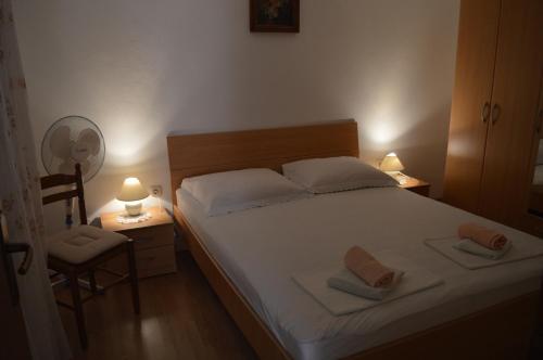 a bedroom with a bed with two towels on it at Apartman Seka in Senj