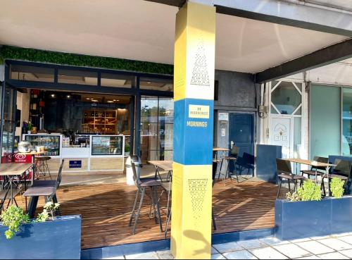 a restaurant with tables and chairs on a wooden deck at M Boutique Apartments in Thessaloniki