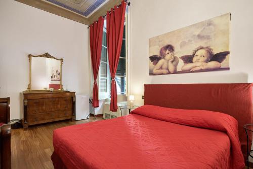 sypialnia z czerwonym łóżkiem i obrazem na ścianie w obiekcie Affittacamere San Teodoro w Albendze