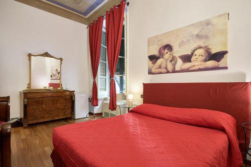 a bedroom with a red bed and a painting on the wall at Affittacamere San Teodoro in Albenga