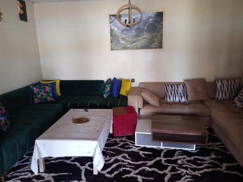 a living room with a couch and a coffee table at ضاية رومي in Dar Caïd Bou Driss