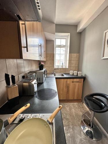 a kitchen with a sink and a counter top at Light Budget Studio Apartment on Edgware Road, Central London in London