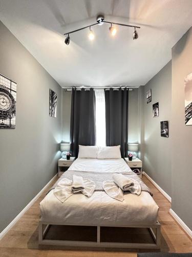 a bedroom with a large bed with a window at Light Budget Studio Apartment on Edgware Road, Central London in London