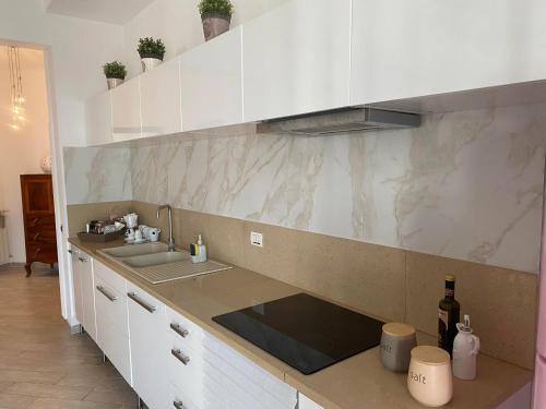 a kitchen with a sink and a counter top at Enjoy in Lido di Ostia