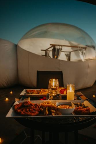 a table with a plate of food and a boat at The Bubble Valley Piet Retief in Piet Retief