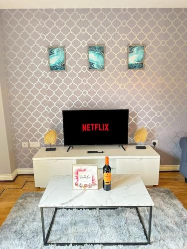 a living room with a tv and a coffee table at Luxury 3 Bedroom House With FREE Parking in Dinnington