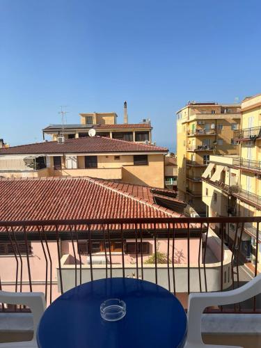 a blue table and chairs on a balcony at Porta sul Mare in Tropea