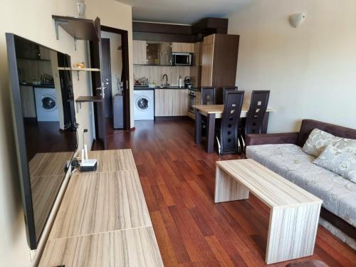 a living room with a couch and a table at Apartment Zlatna kotva in Golden Sands