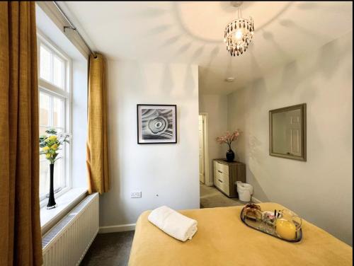 a room with a bed and a large window at Suitely Stays Berkeley Apartment 2 in Cheltenham