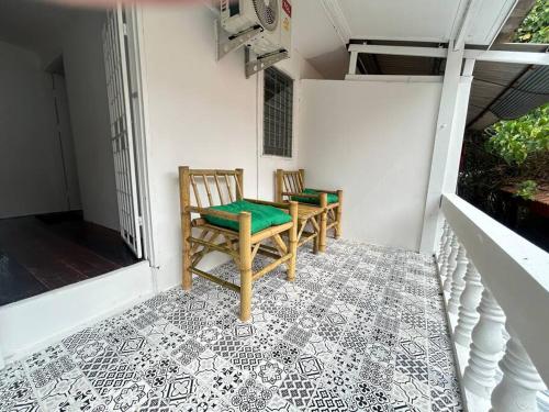 two chairs on a porch with a tiled floor at Townhouse nearby Klong Dao beach in Ban Mo Nae