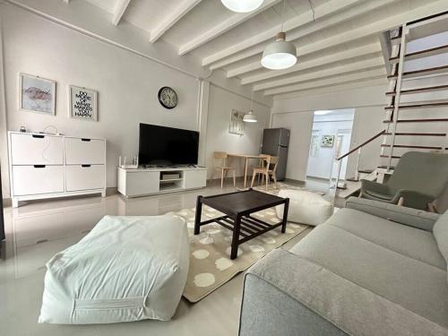 a living room with a couch and a table at Townhouse nearby Klong Dao beach in Ban Mo Nae