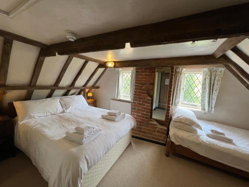 a bedroom with two beds and a window at Strand House in Winchelsea