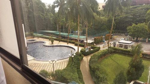a view of a swimming pool from a window at Seaput Srisayang in Batu Ferringhi