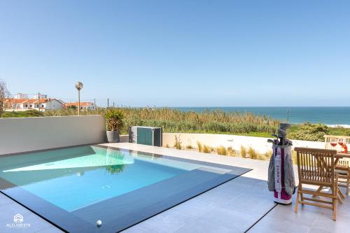 a swimming pool with a view of the ocean at CasaDami - Santa Cruz in Santa Cruz