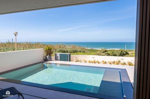 a swimming pool with a view of the ocean at CasaDami - Santa Cruz in Santa Cruz