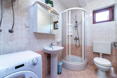 ein Badezimmer mit Dusche, Toilette und Waschbecken in der Unterkunft Marina in Baška