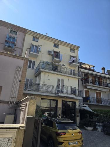 a yellow car parked in front of a building at Appartamento Mare in San Benedetto del Tronto