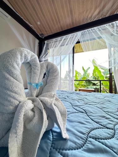 a bedroom with a bed with towels on it at Villas In Sueño Private Jungle Hotel in Manuel Antonio