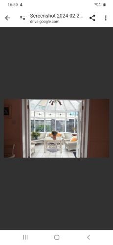 a picture of a living room with a table at Hazelbrook Guesthouse in Waterford