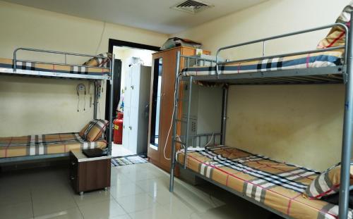 a room with two bunk beds and a doorway at Women Only Hostel near Burjuman Metro exit 4 in Dubai