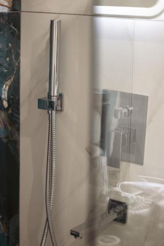 a shower in a bathroom with a glass door at Emily Apartments 2 in Chrysoupolis