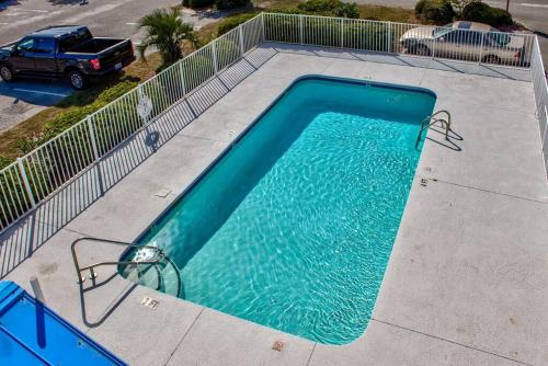an empty swimming pool in a parking lot at Kraken's Den * Oceanview * Steps to ocean * Pool in Carolina Beach