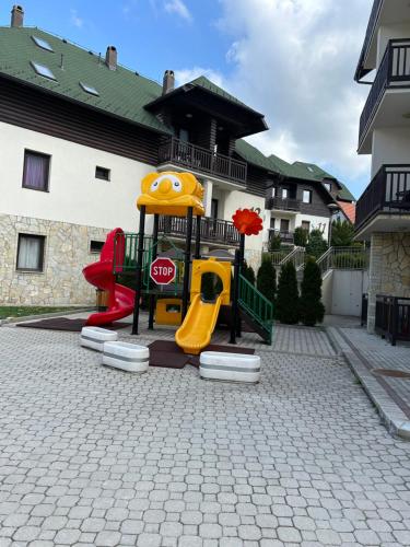 a playground with a stop sign on it at Zlatiborski konaci- apartman Katarina in Zlatibor