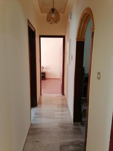 a hallway leading to a room with an open door at Anastasia's Apartment ΛΑΥΡΙΟ in Lávrion