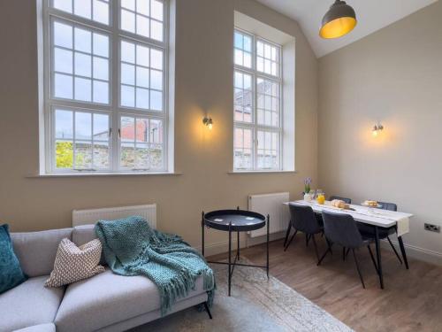 a living room with a couch and a table at Exceptional Holiday Home 7 in Pickering with Hot Tub in Pickering