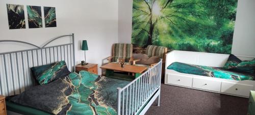 a bedroom with a bed and a couch at Penzion Axiom in Frymburk