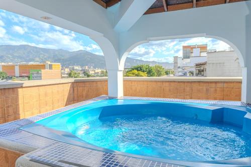 a hot tub on the roof of a building at Hotel Alcaravan Medellín in Medellín