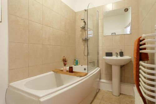 W łazience znajduje się umywalka, wanna i umywalka. w obiekcie Cozy Downtown Loft in Bradford w mieście Bradford