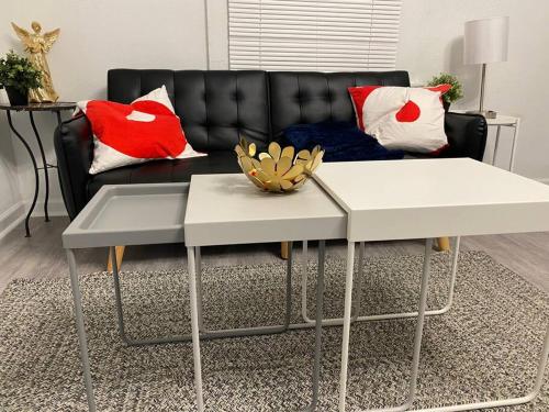 a living room with a couch and a coffee table at Cozy Studio Bungalow Steps To Armature Works in Tampa