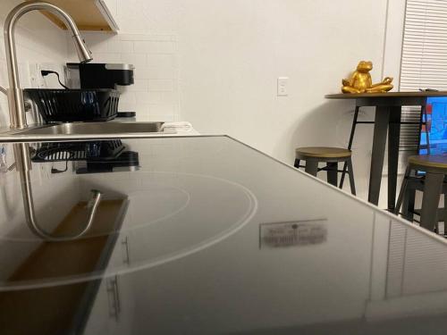 a white kitchen with a counter top and a sink at Cozy Studio Bungalow Steps To Armature Works in Tampa