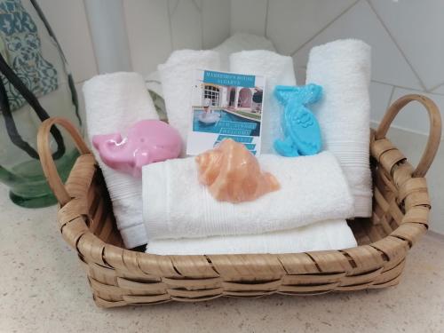 a basket filled with towels and a stuffed animal at Marreiro's house Algarve - Child friendy - Private Pool in Lagos