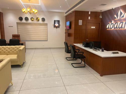 a lobby with a waiting room with a couch and chairs at Hotel Abaam Neil in Alleppey