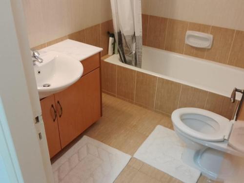 a bathroom with a toilet and a sink at Coral View in Peyia