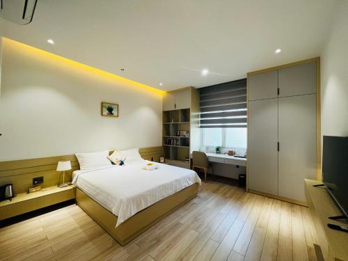 a bedroom with a bed and a desk in it at Bibi’s home in Danang