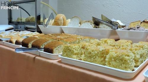 a buffet of different types of bread and pastries at HOTEL PRINCIPE in Governador Valadares