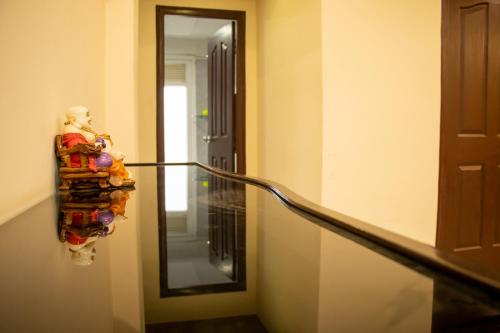 a mirror on a wall next to a stair case at Vara in Varanasi