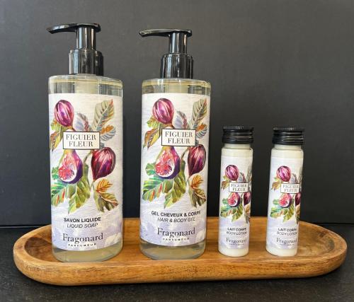 three bottles of facial moisturizers on a wooden tray at Les Hauts de la Riviera in Cabris